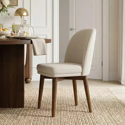 Table à manger ronde de style Mid-Century avec plateau en placage de noyer, piétement croisé en bois massif et chaises en lin avec pieds en bois massif.